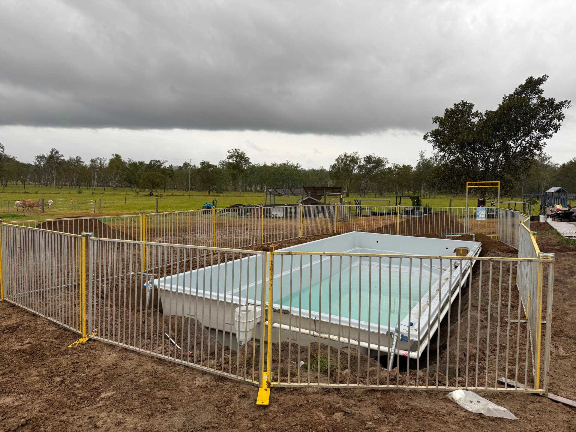 Temporary pool fencing around a new fibreglass pool on acreage