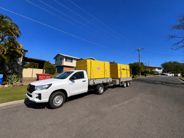 Aus Fence Hire truck carrying yellow temporary fencing panels
