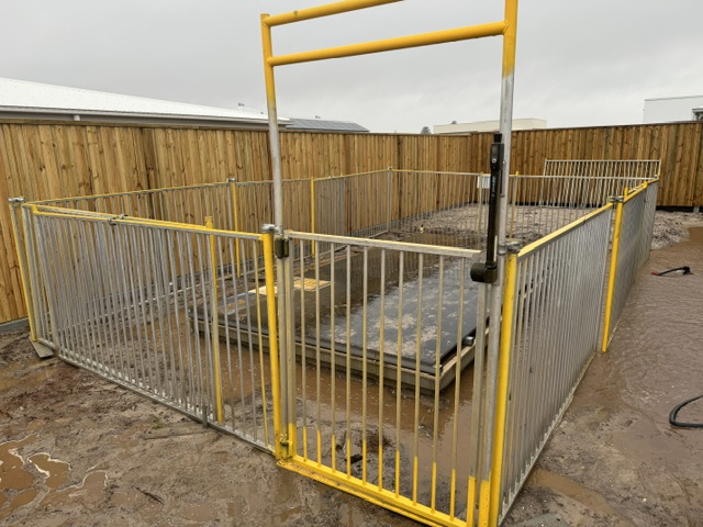 Yellow and aluminium temporary pool fencing with a self closing gate