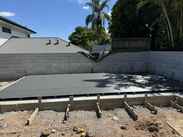 Completed hard pool platform viewed across the pool shell