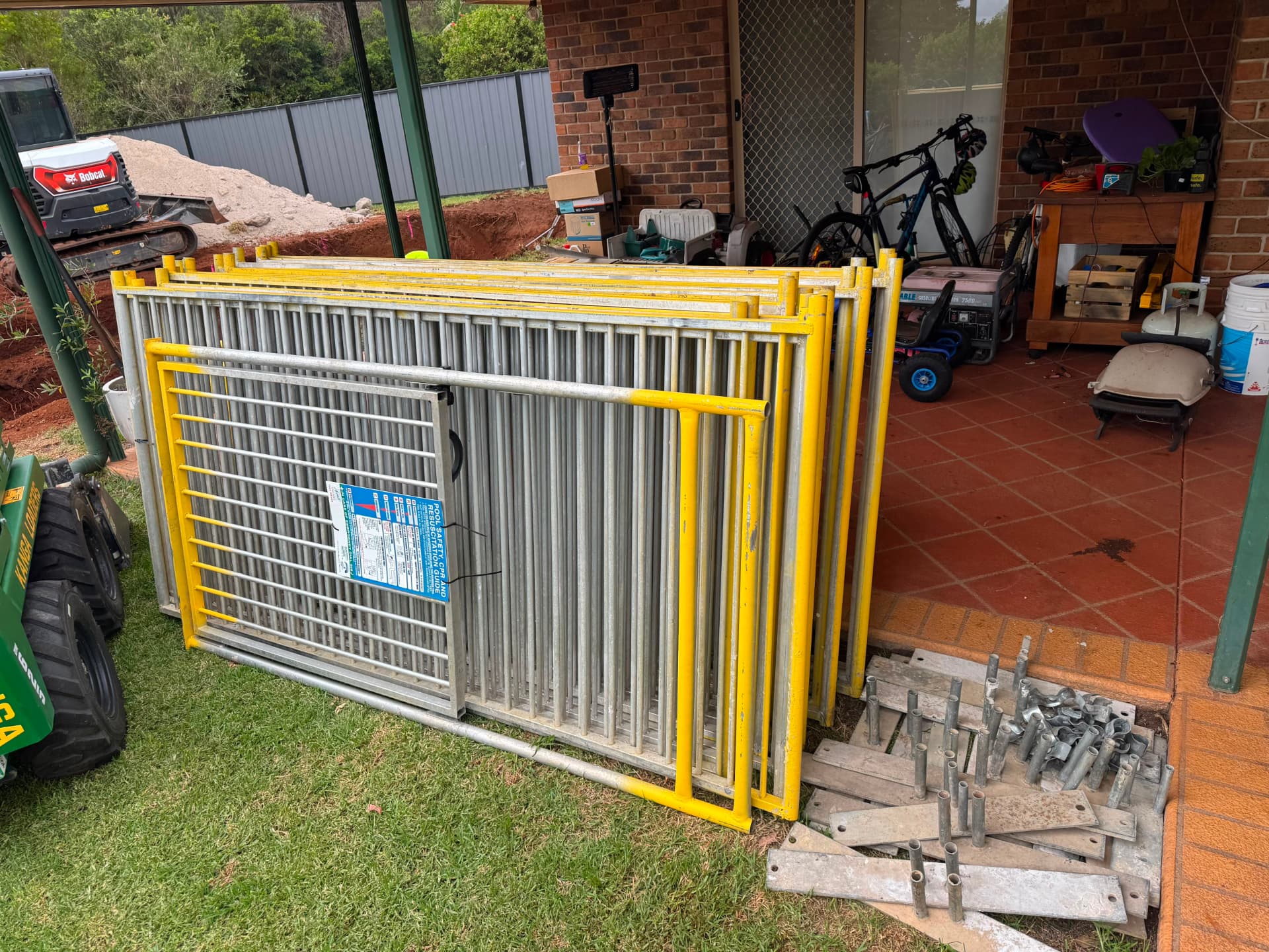 Pool fencing and gate delivered on site with safety signage