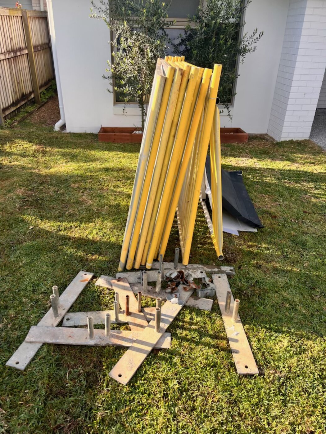 Stacked yellow fence panels ready for delivery
