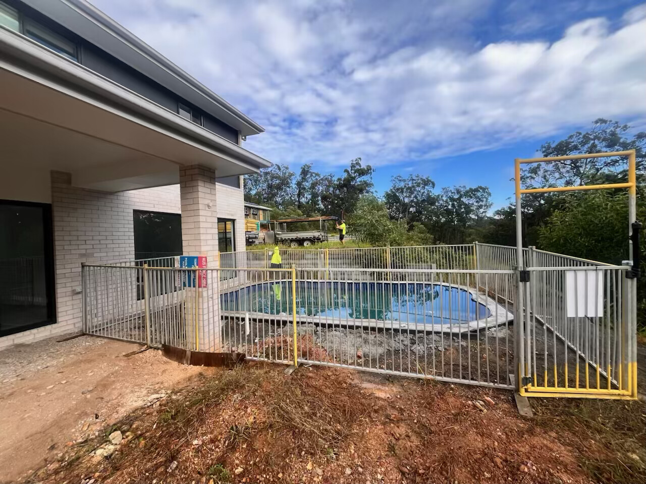 Temporary fencing installation at a modern residential construction site