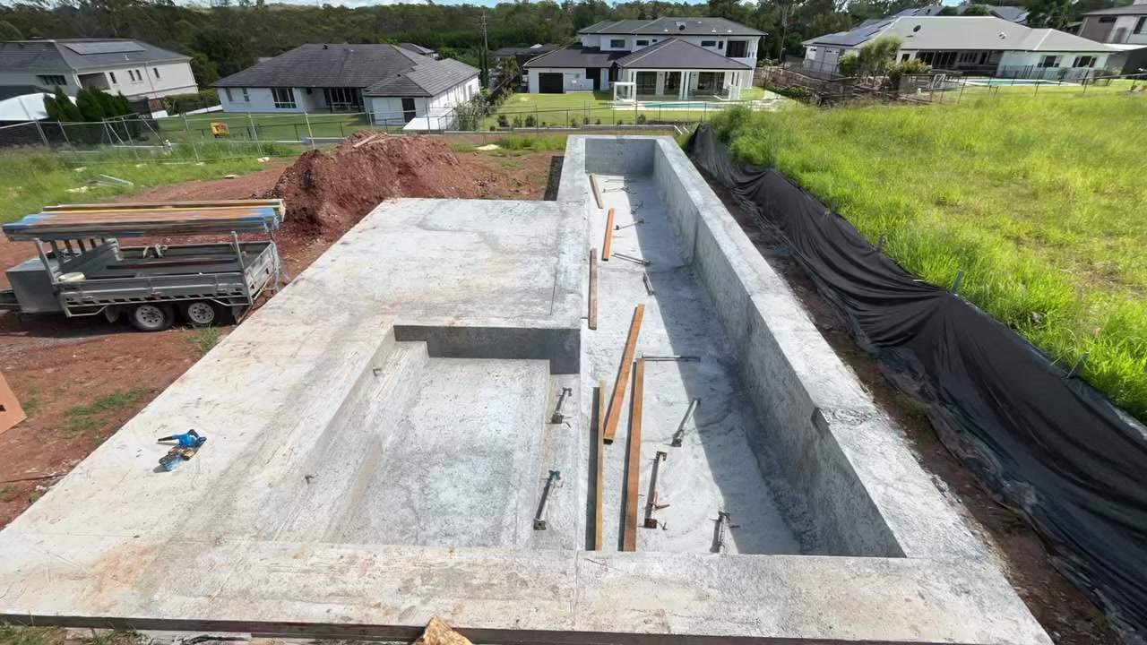 Concrete pool covered with a custom pool platform before