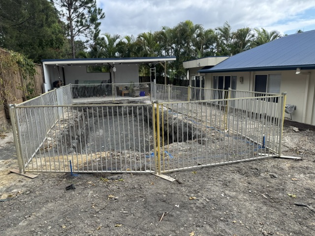 Temporary aluminium fencing securing an excavated residential pool site