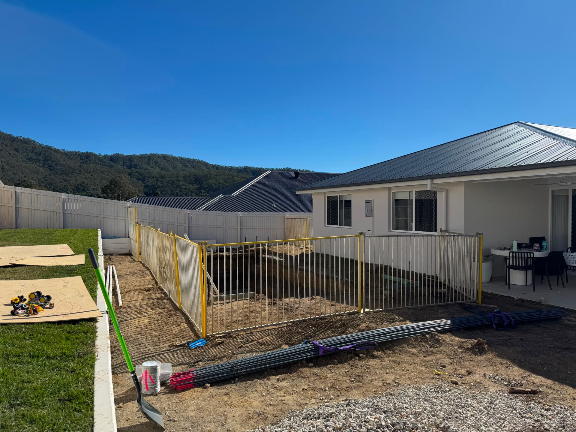 Temporary pool fencing around a new pool excavation