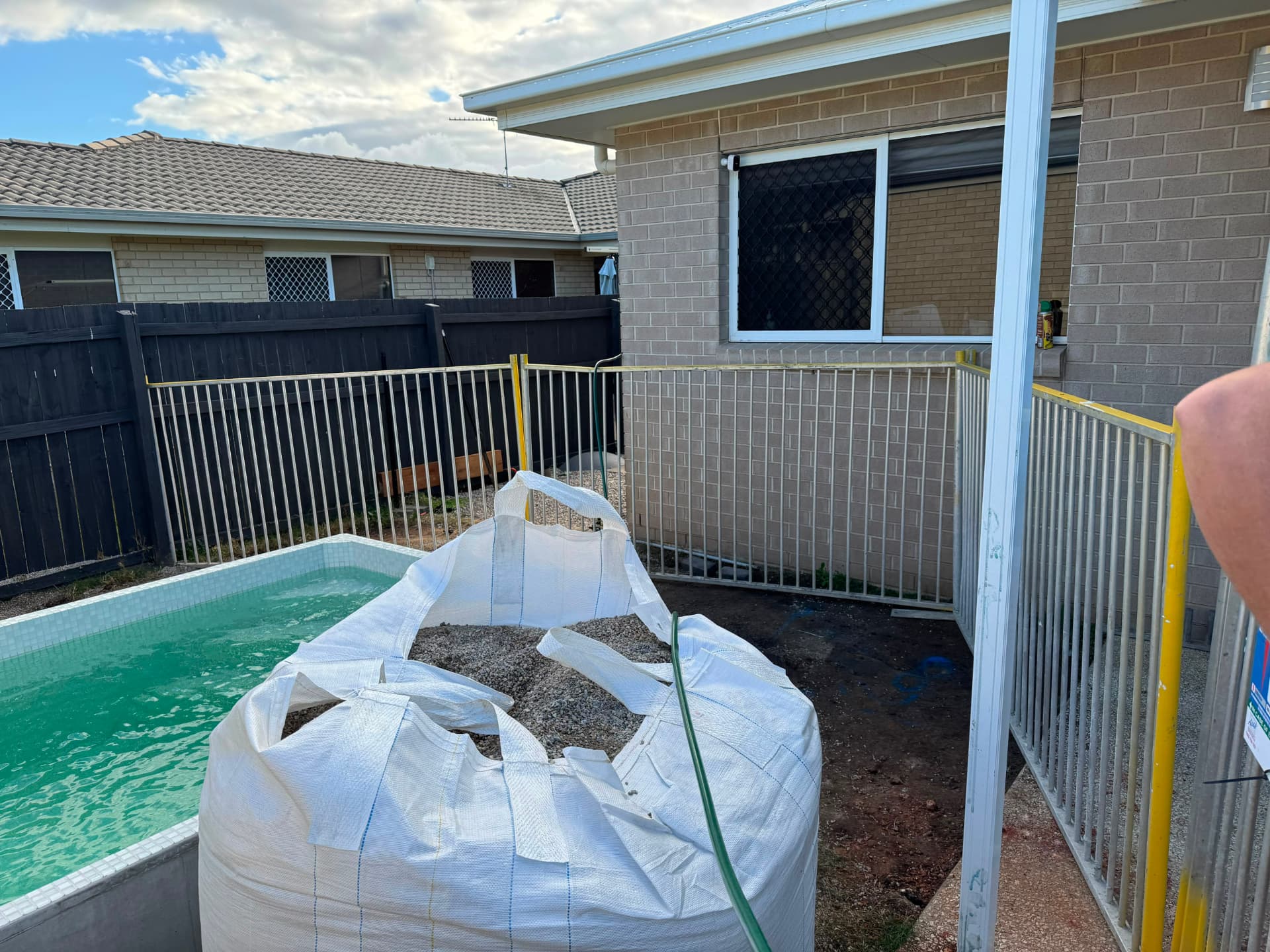Temporary pool fencing beside an existing pool