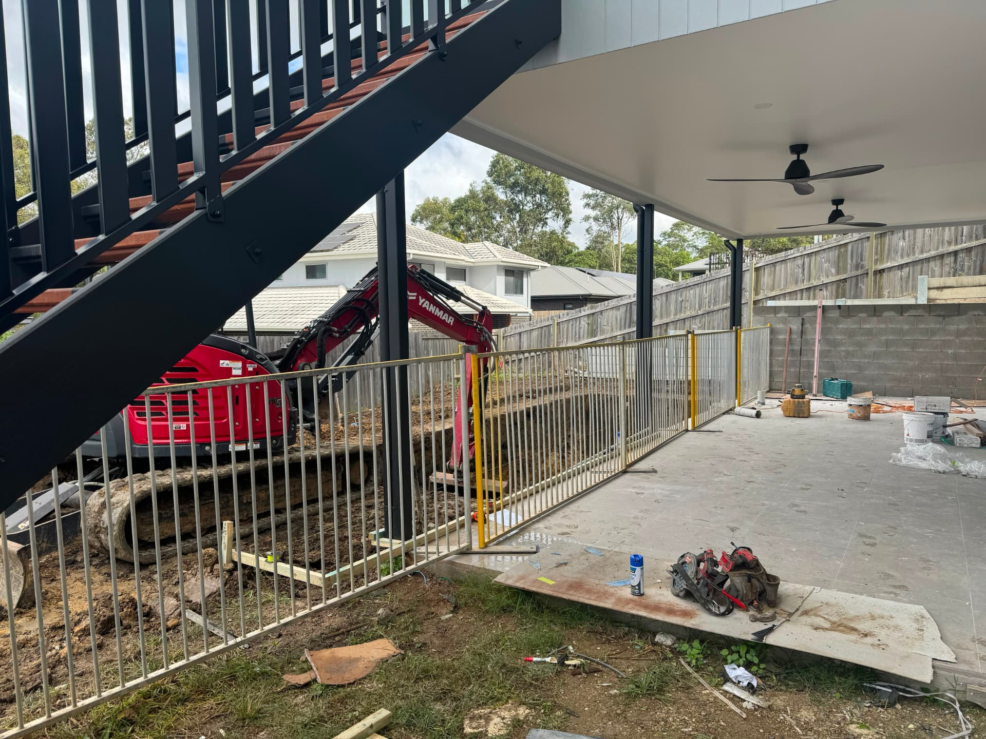 Temporary pool fencing securing an excavation next to an alfresco