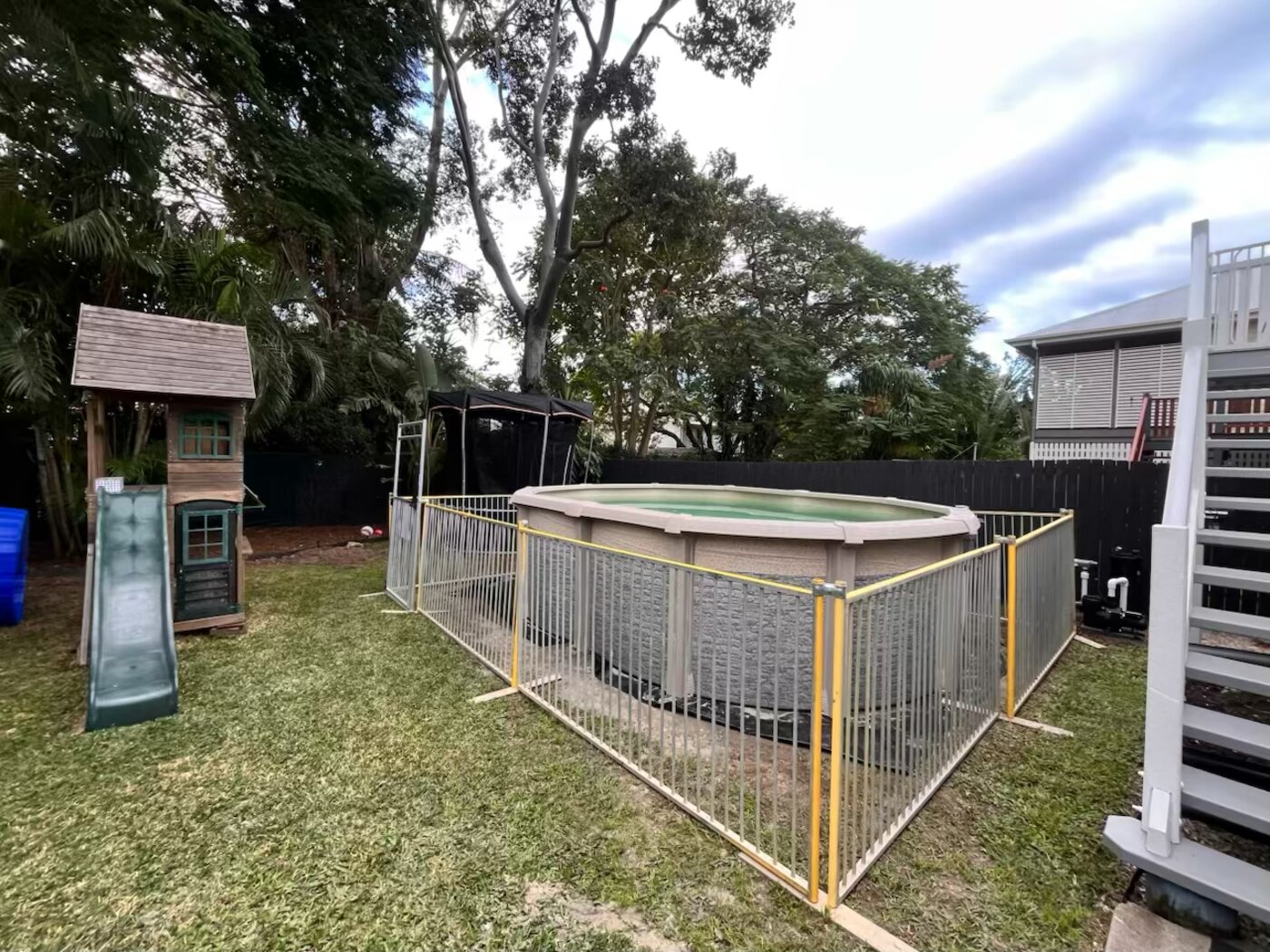 Yellow fence around backyard pool in Brisbane